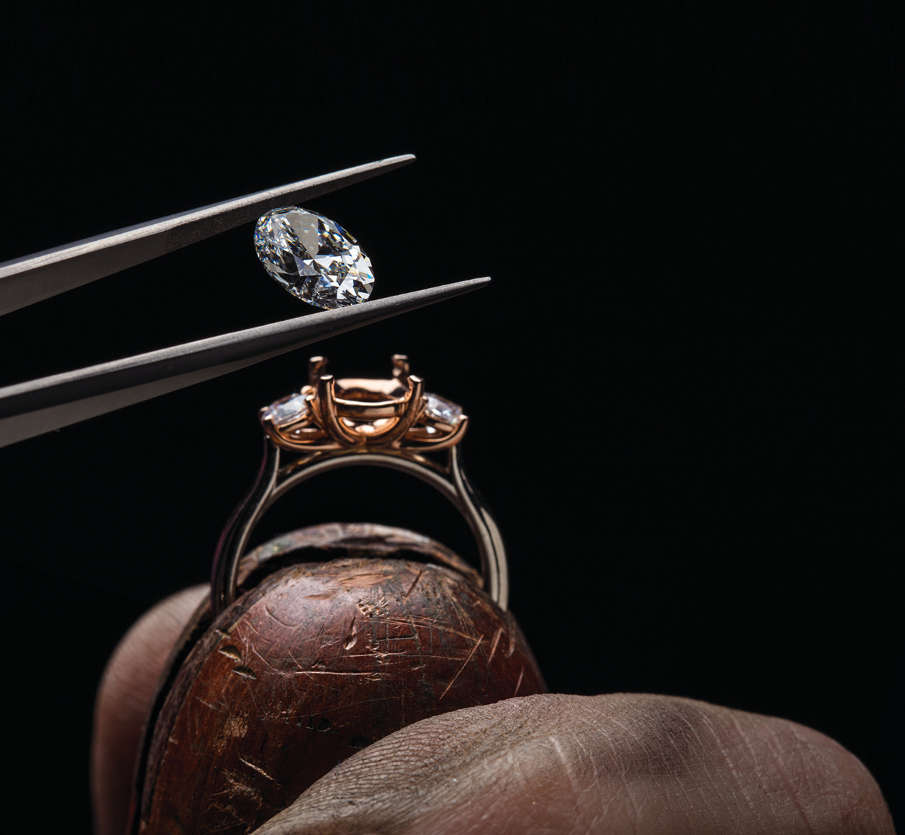 A jeweller carefully crafting a fine jewellery piece